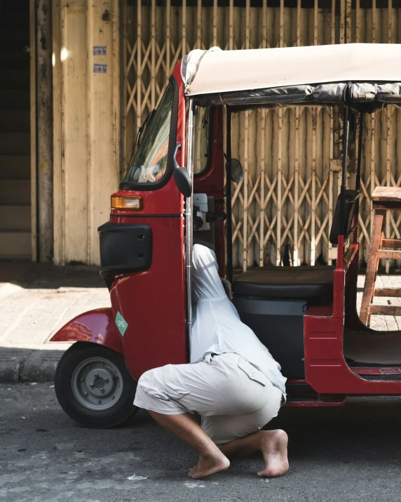 a man in white shirt pulling a luggage cart