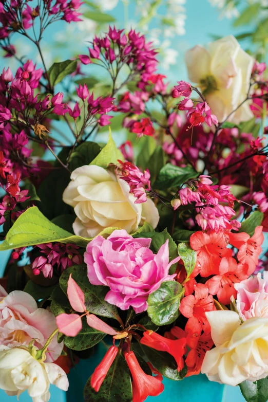 a bunch of pink and white flowers in a blue vase