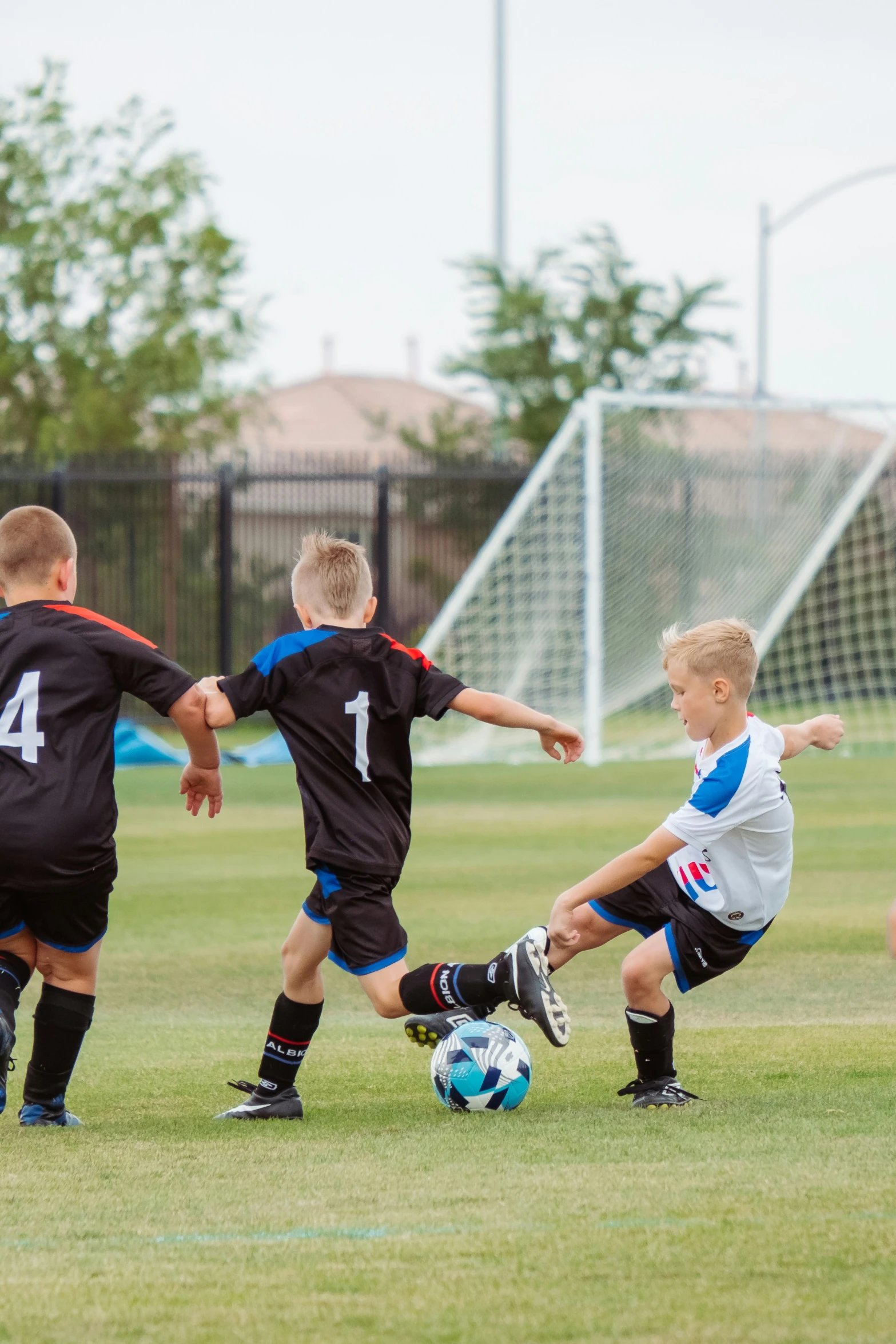 some s are playing soccer on a field