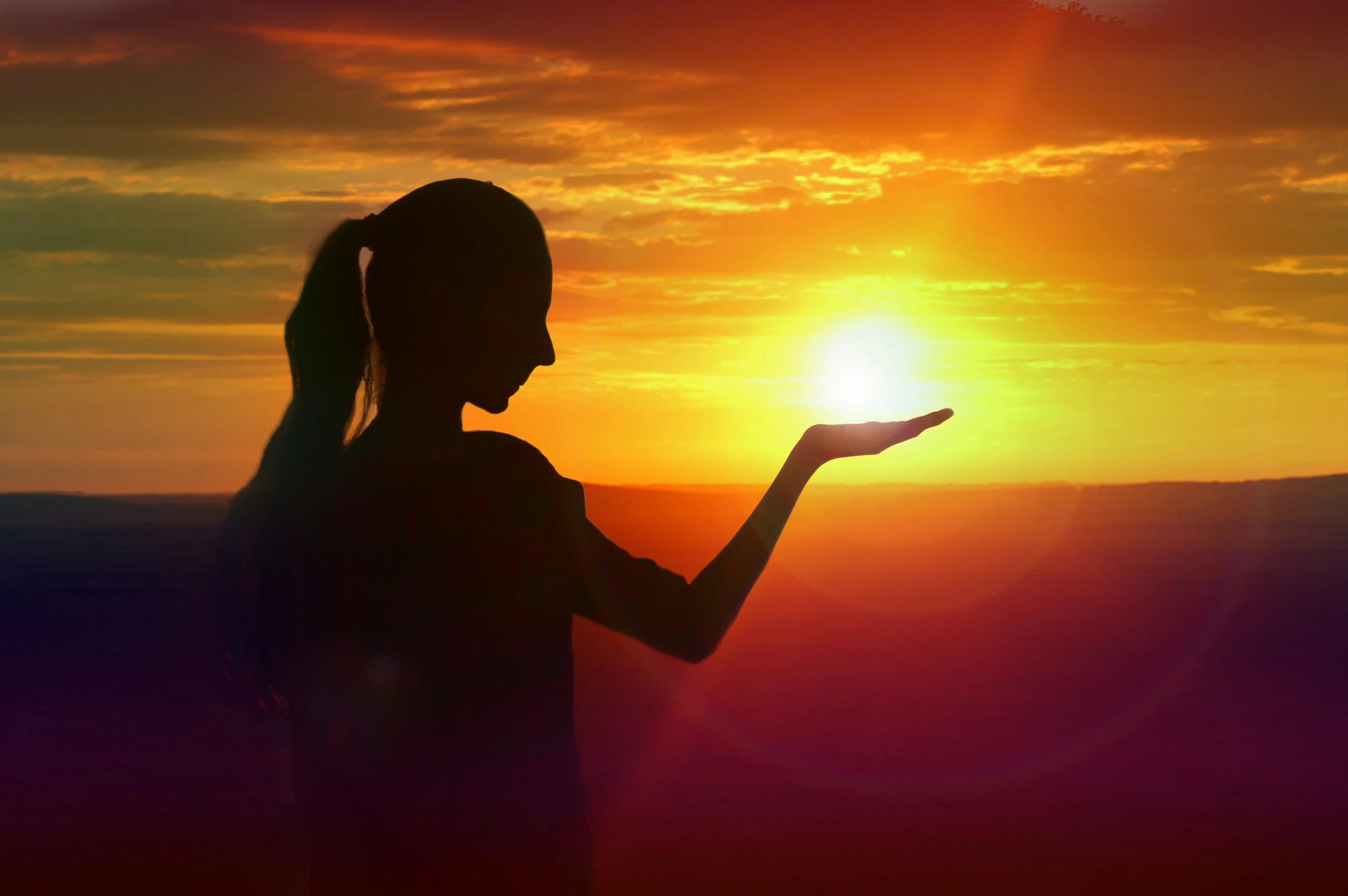 the woman is standing in front of the sunset