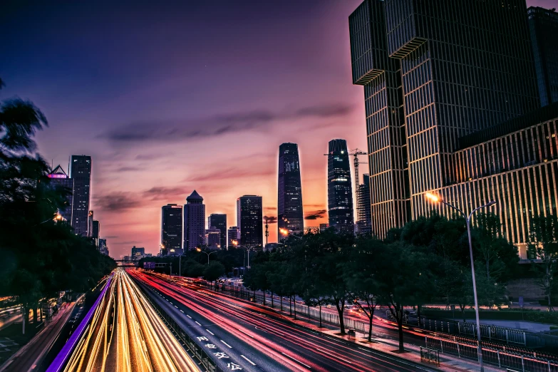 a highway with lights that are glowing from cars