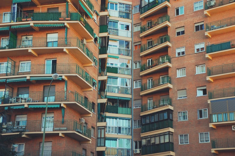 the facade of the tall building has balconies