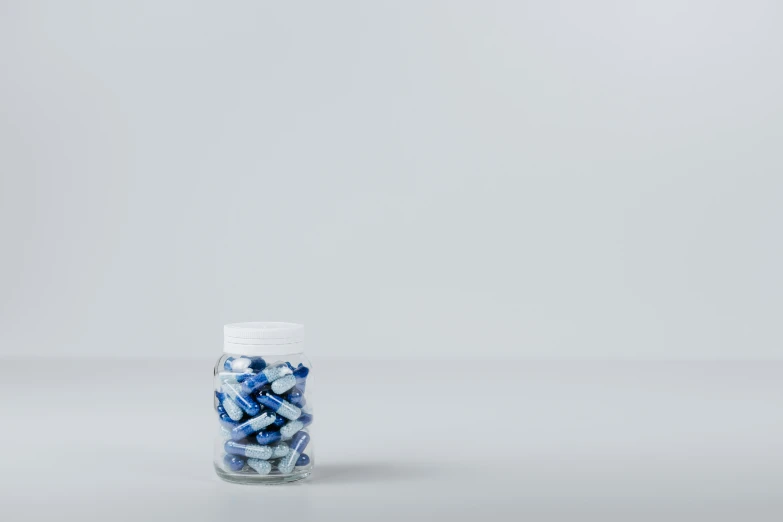 a blue pills container sitting on top of a table