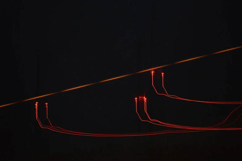 a telephone pole in front of dark sky with lights