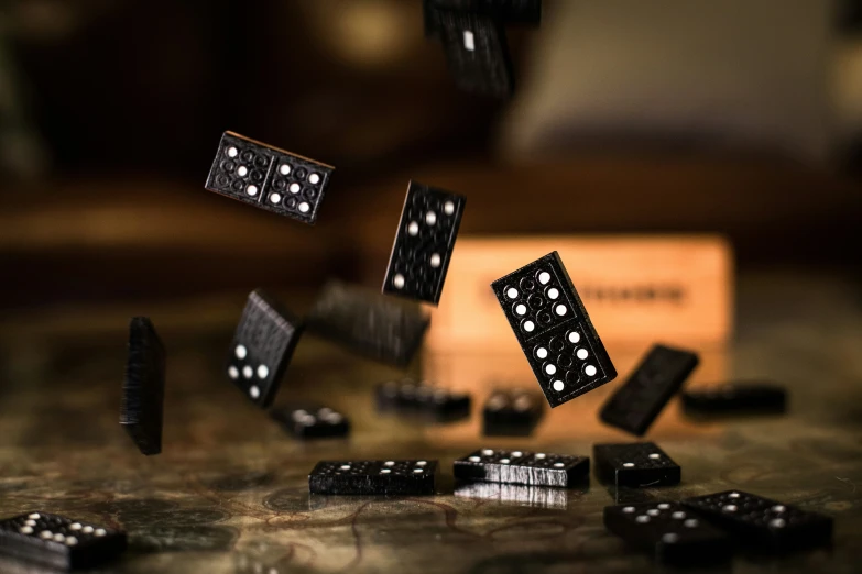 two dice are in mid air with dice scattered on the table