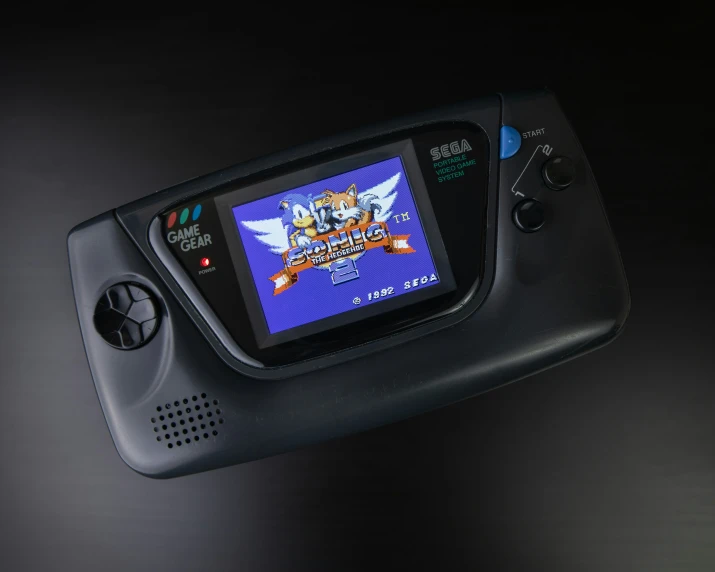 an old - fashioned handheld game system displaying the screens