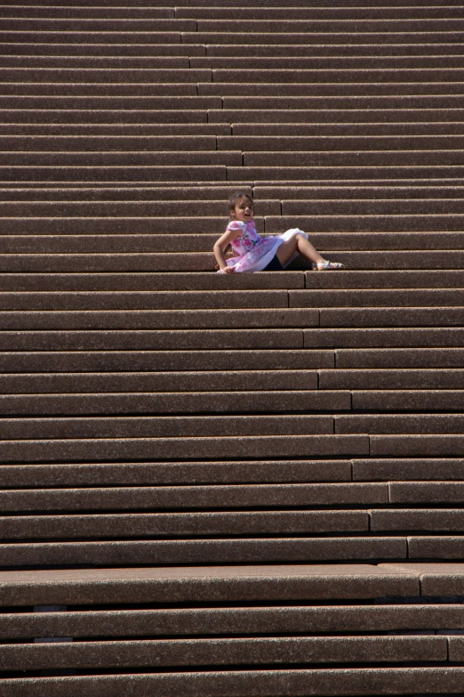 a person laying in the middle of some stairs