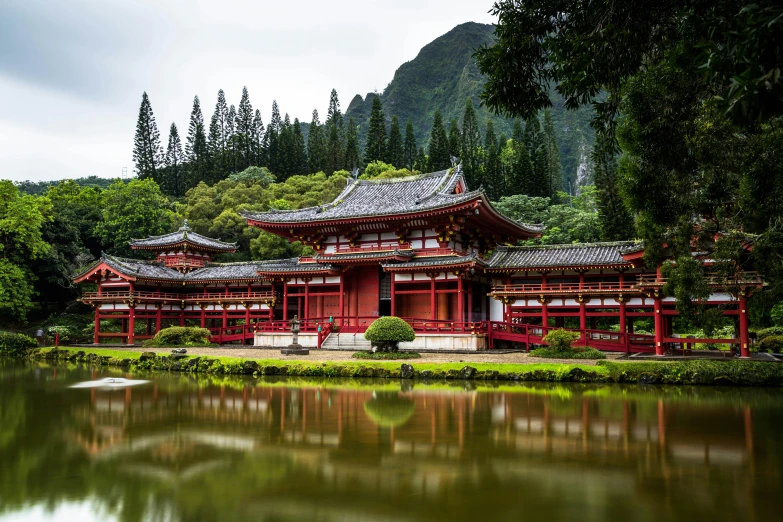 a small shrine on the side of a lake