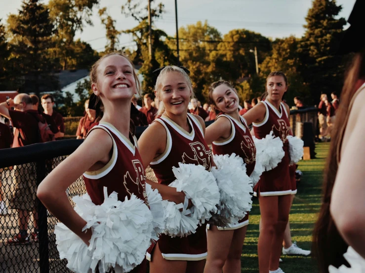 girls cheerleaders and their skirts stand in formation before the game