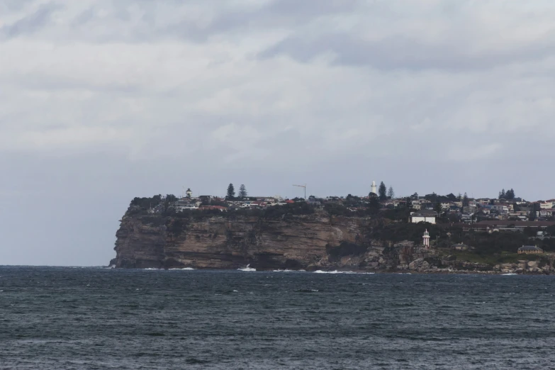 the city sits atop a rocky island on the ocean
