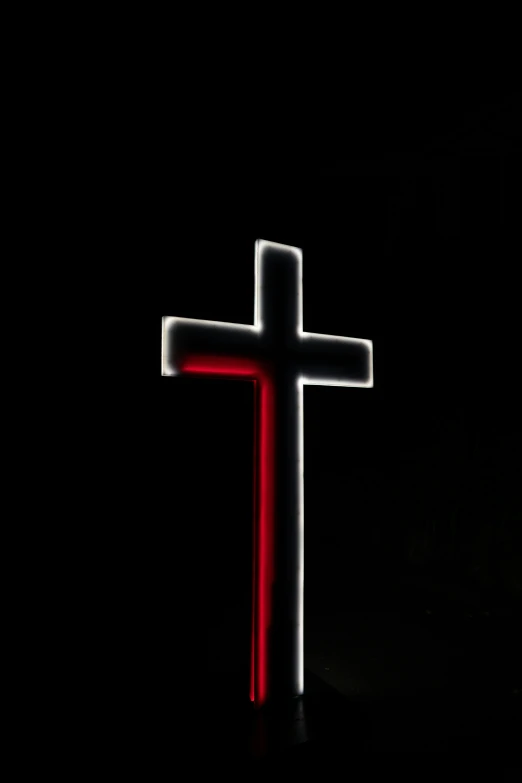 a cross light up on a black background