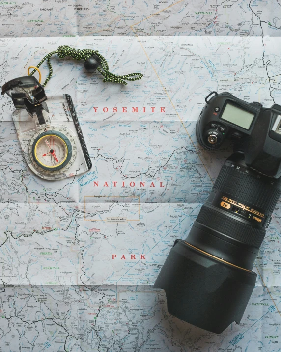 a camera and a couple of keys on a map