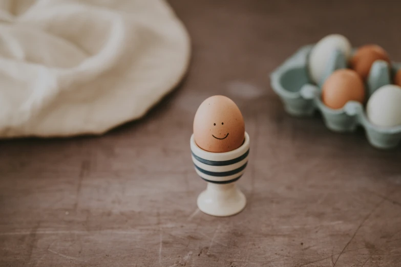 an egg with an image on it next to other eggs