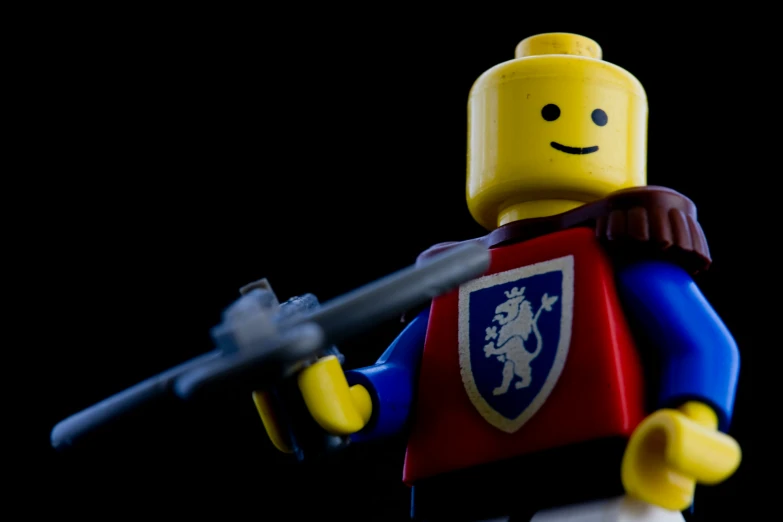 the lego figurine has a gun in his hand