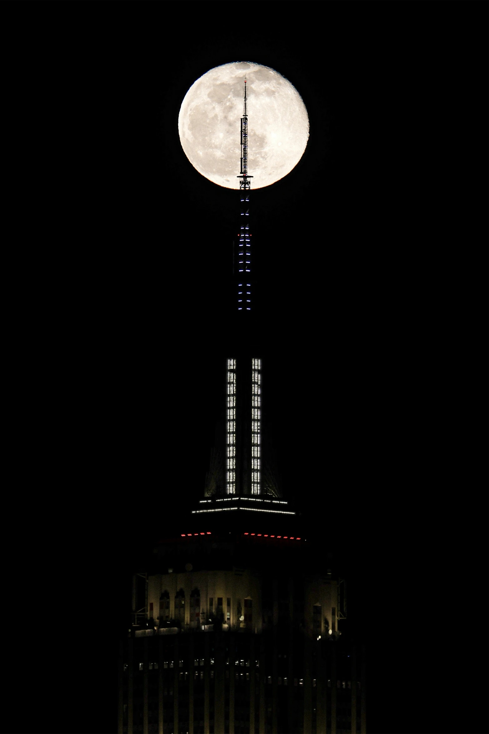 the top of a building with a lit up moon on it