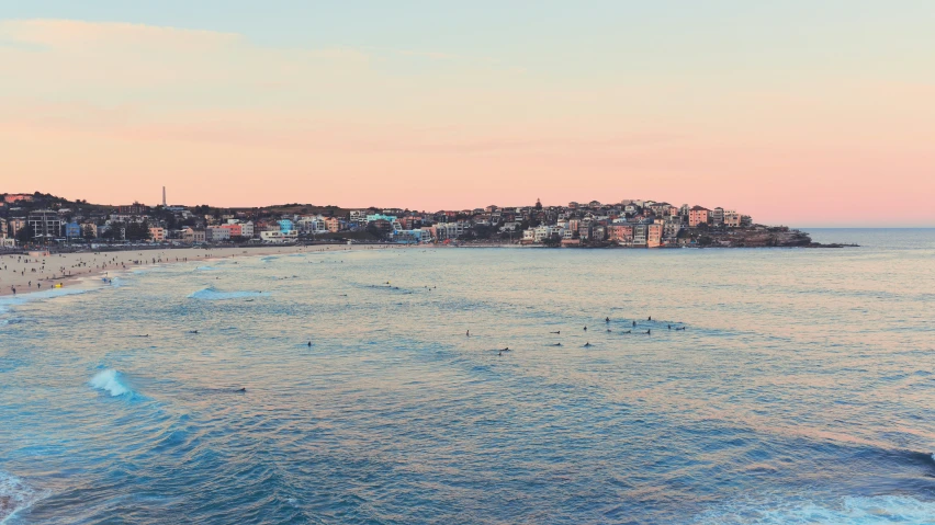 view of city with beach at sunrise or dawn