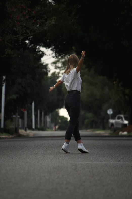 a young lady is having fun on her skateboard