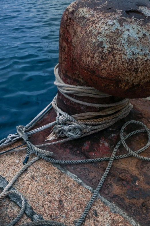 a rope is wrapped around a rusty boat bow