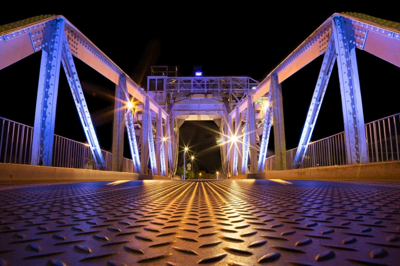 there is a very tall blue bridge going over it