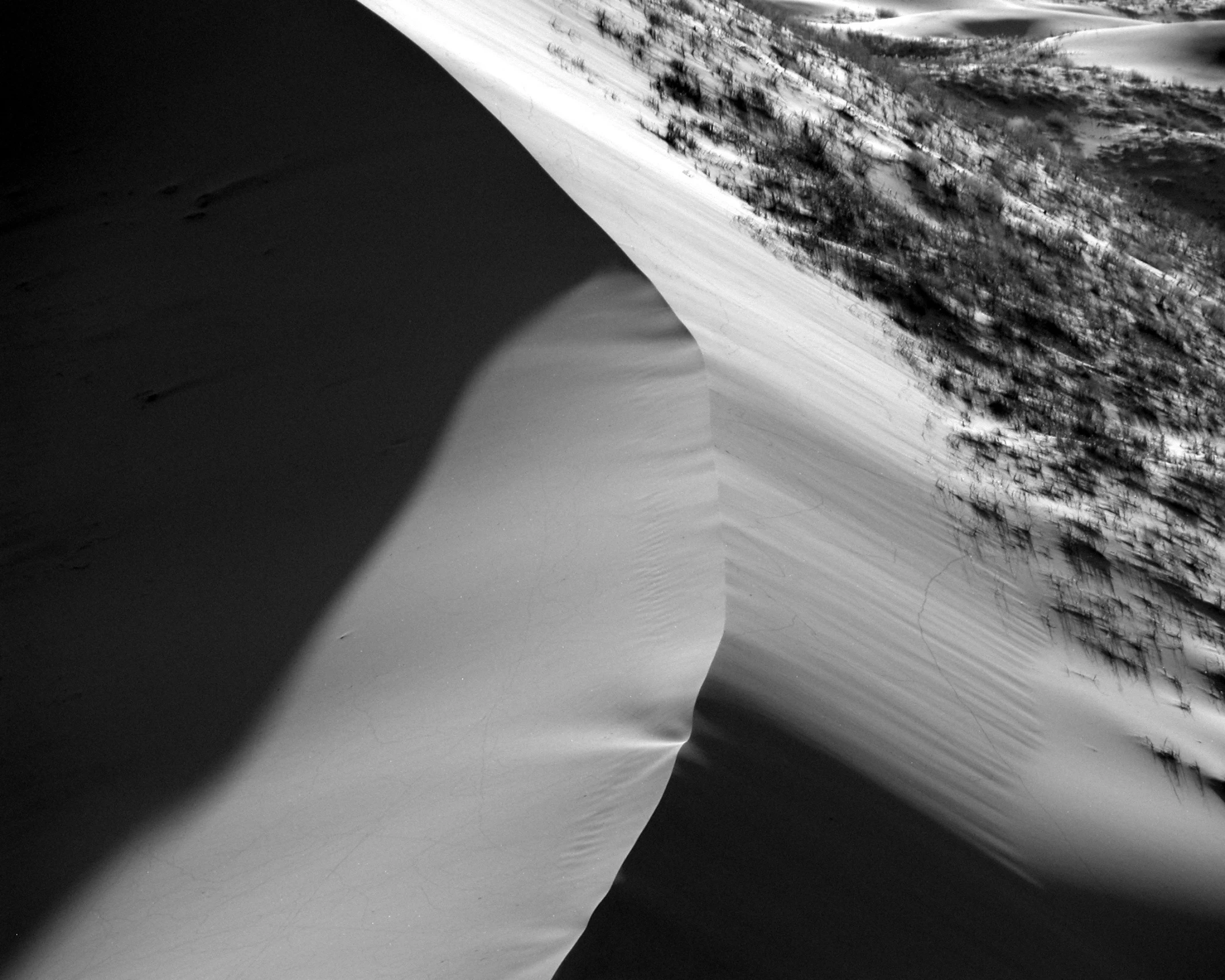 an aerial view of a long dune in a desert area