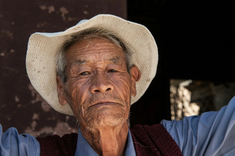 a man wearing a hat making a face with his hands