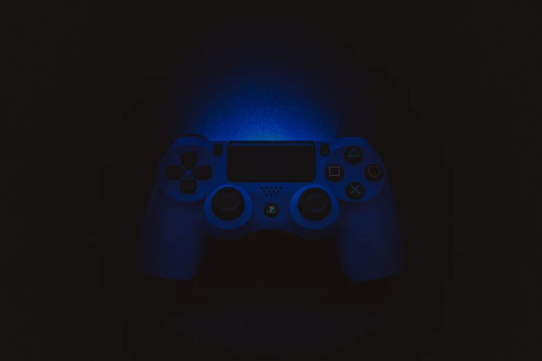 a close up s of a game controller glowing blue