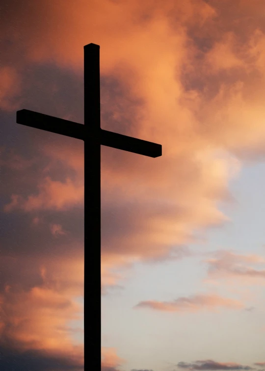 a cross with a sky background and a bird flying in the air