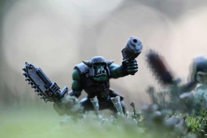a miniature warhammer is posing with his arms out in the air