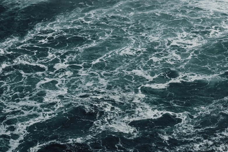 a boat floats through rough waves in the ocean