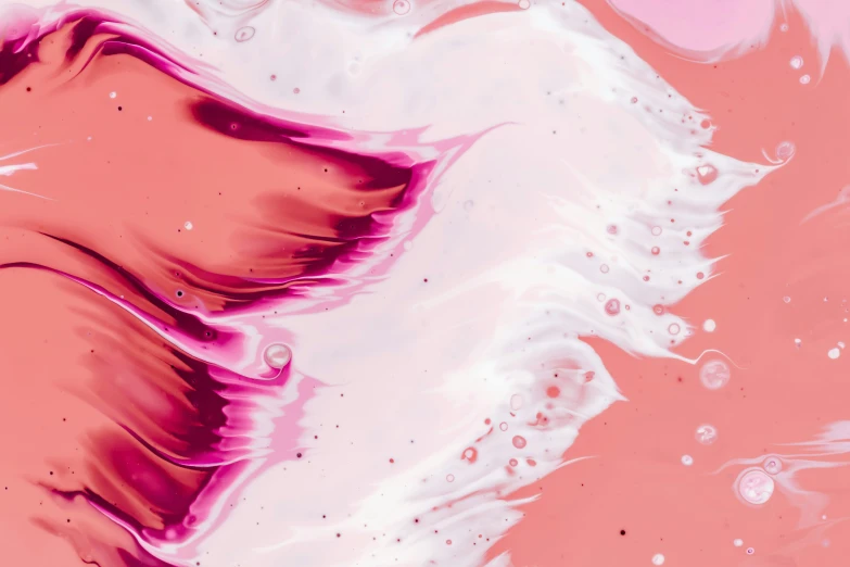 pink and white paint and liquid inside a glass