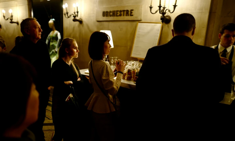 people are gathered in a bar for drinks