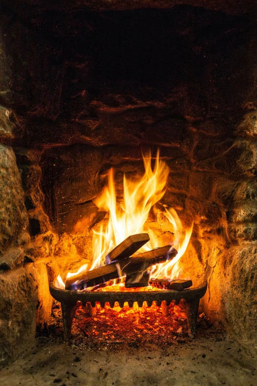 a fire burns in a stone fireplace, closeup