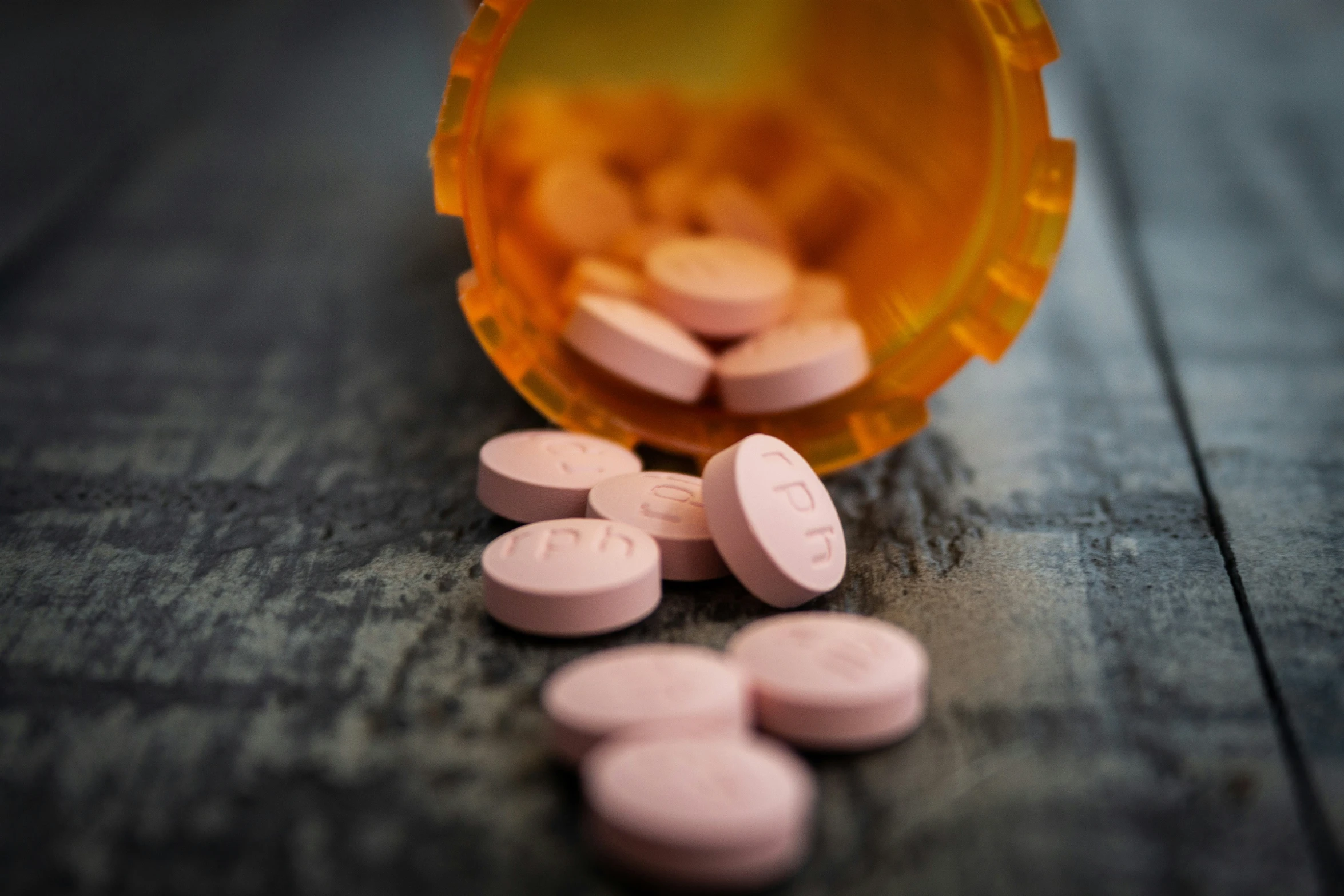 pill pills sit upon a wooden table top