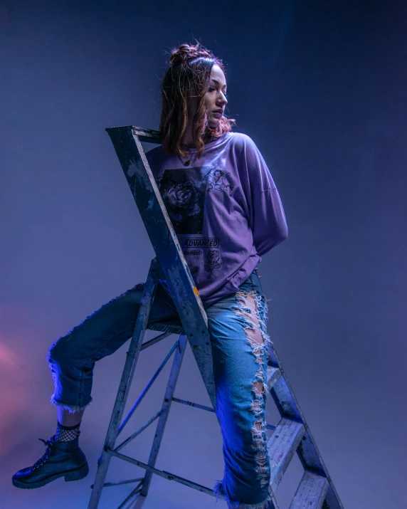 man sitting on a step ladder making silly face