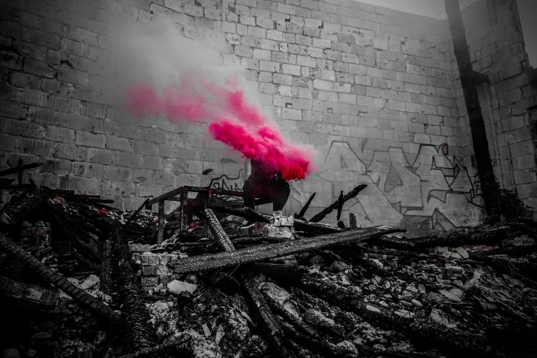 a black and white po of pink smoke coming from a fire hydrant