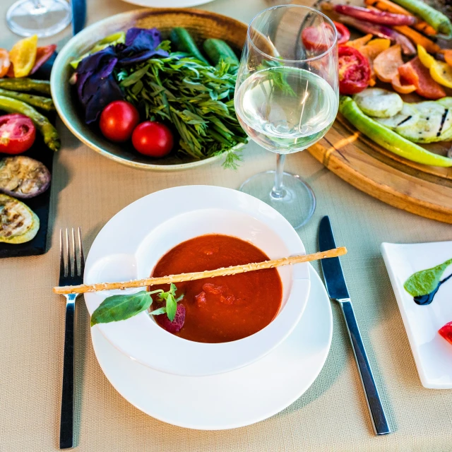 a meal that includes vegetables and some wine