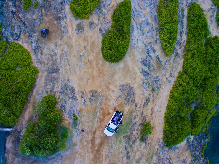 an aerial view of the road and some vehicles parked on land