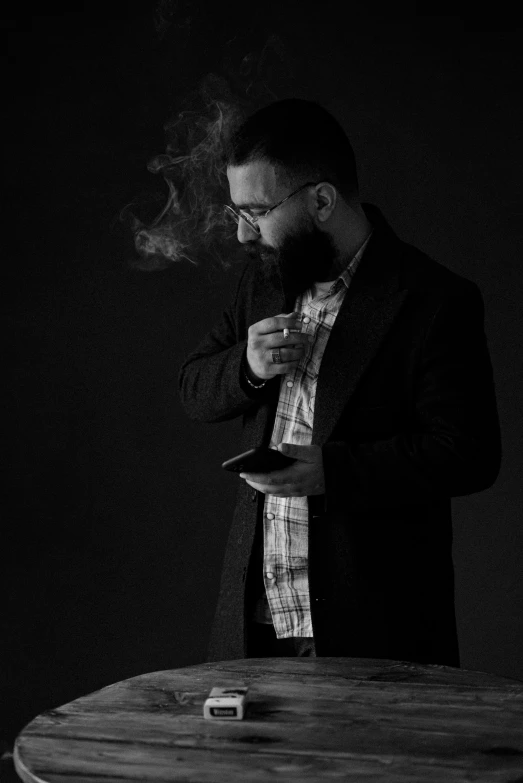 a man smoking cigarette on top of a table