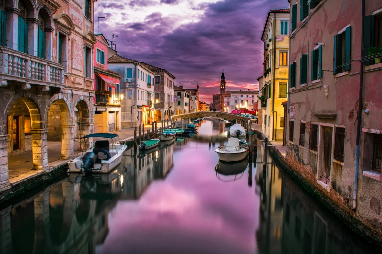 a waterway that has boats on the side and buildings next to it