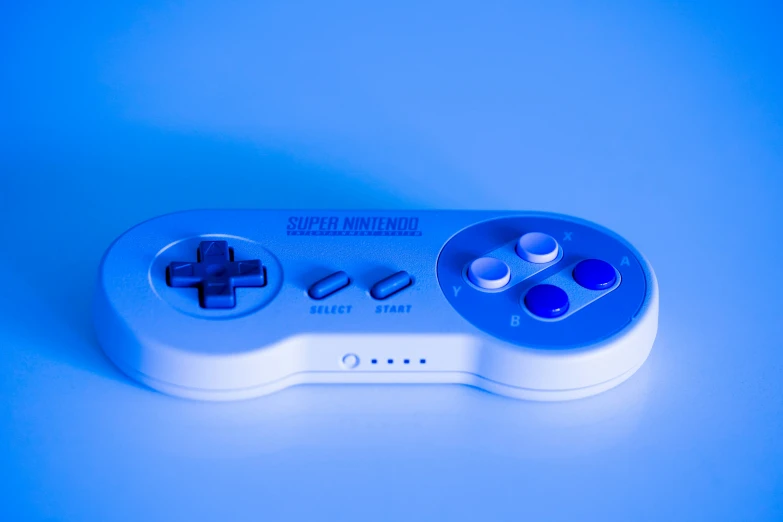 a wii remote sitting next to each other on a blue surface