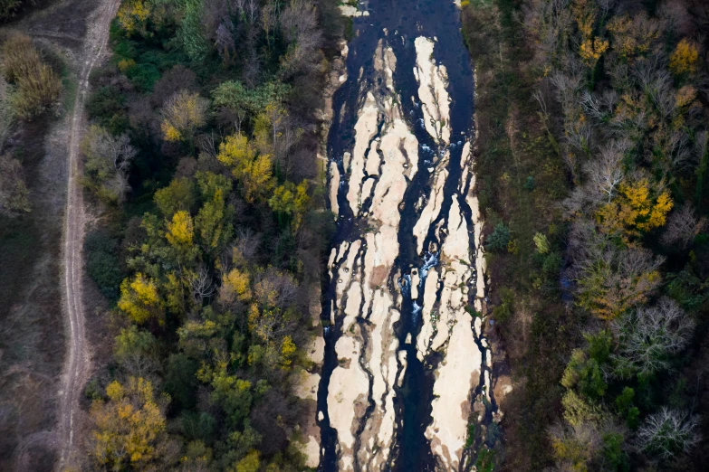 an aerial view of the water on a large dirt road