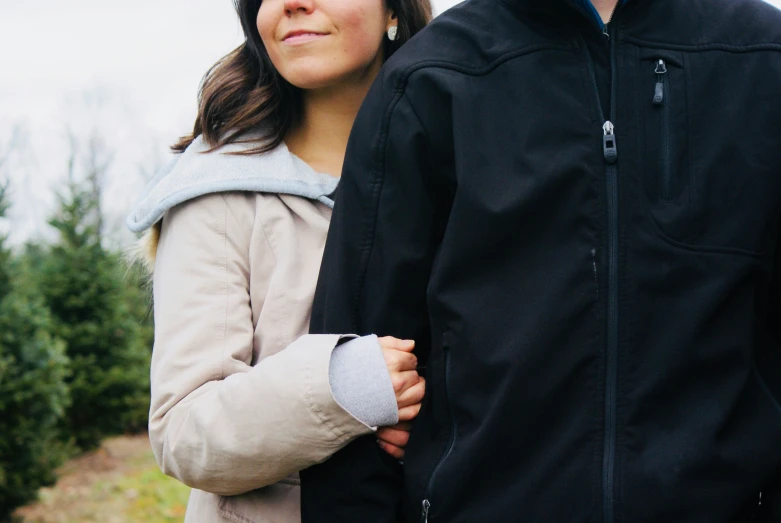 the man is holding onto the woman's hand