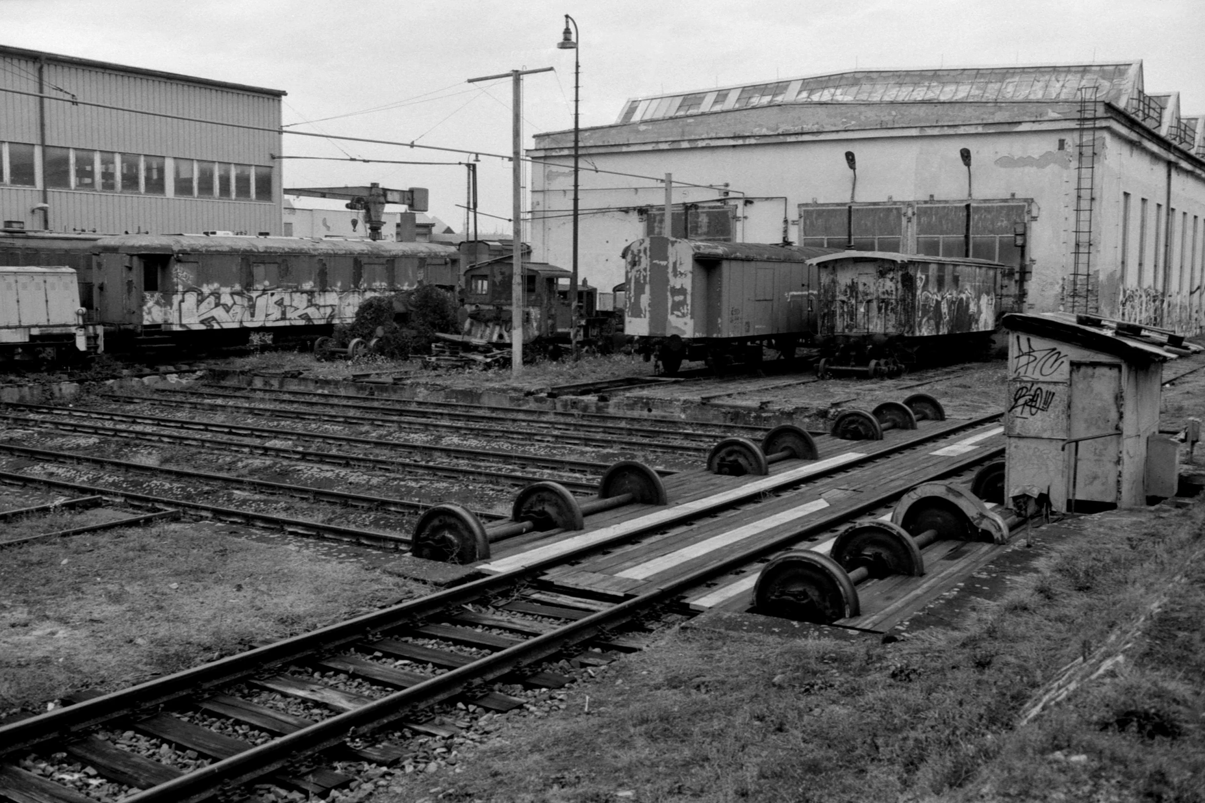 several railroad tracks run in front of some buildings