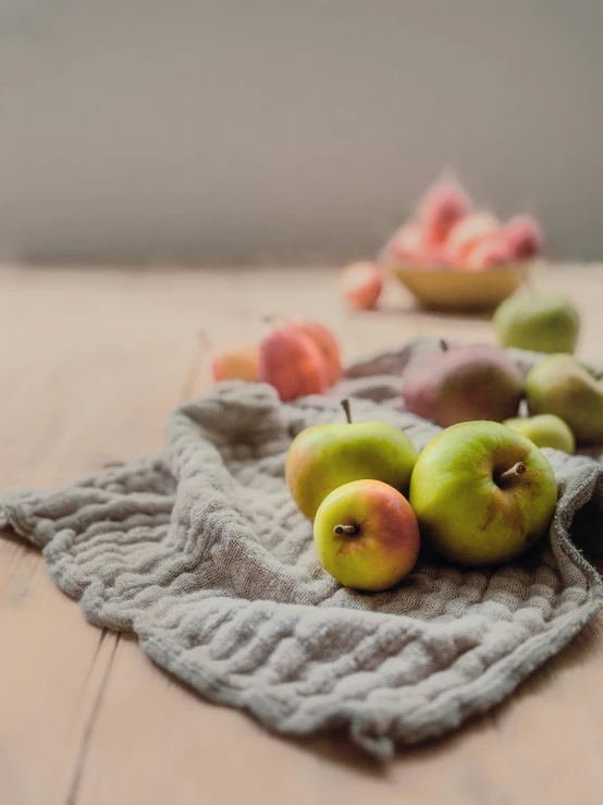 apples and oranges in a bowl on the floor