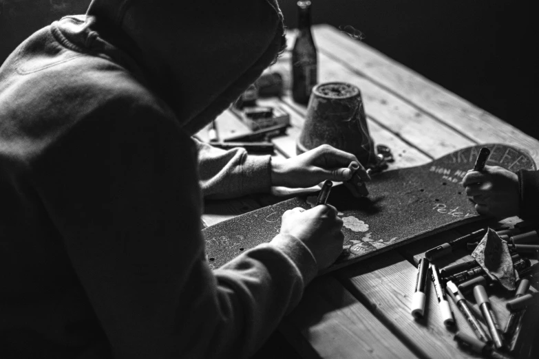 a man making soing with a pair of pliers