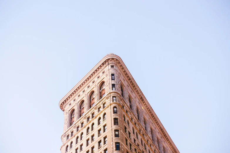 a very tall building is shown with an american flag on the corner