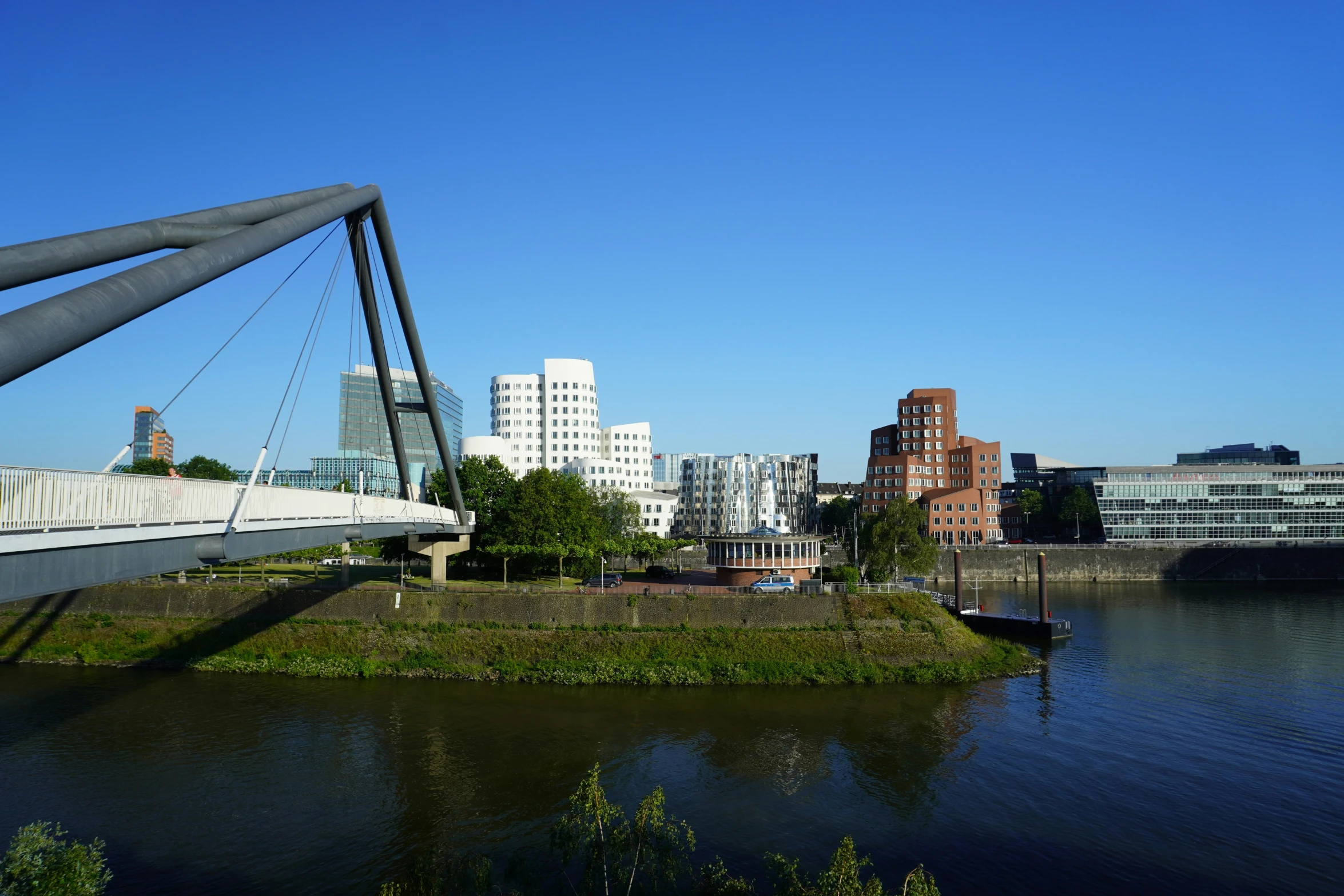 the bridge stretches along the river in front of a city skyline