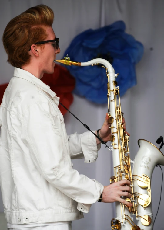 a woman playing a saxophone while wearing glasses