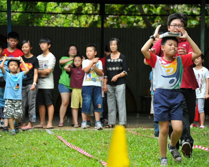 the  is holding up a frisbee and trying to take him off