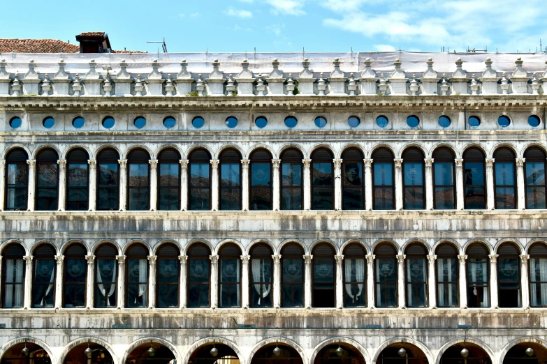 an architectural building has oval and curved windows